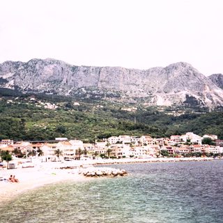 Coastal town nestled between mountains and sea.