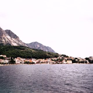 Coastal town nestled between sea and mountains.
