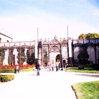 Elegant garden pavilion with ornate ironwork entrance.