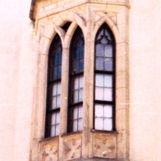 Medieval-style castle facade with heraldic crest.