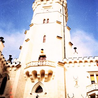Medieval-style tower with crenellated walls and decorative stonework.