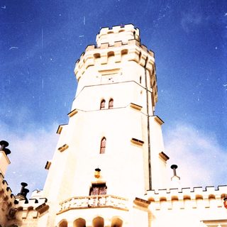 Medieval-style tower with crenellated walls and decorative stonework.