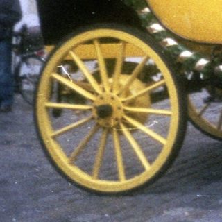 Elegant horse-drawn carriage with yellow and black trim.