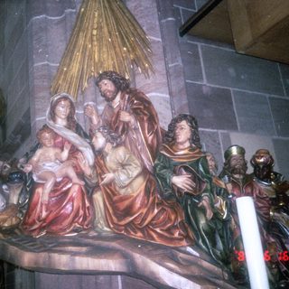 Religious nativity scene with Virgin Mary, baby Jesus, Joseph, and shepherds.
