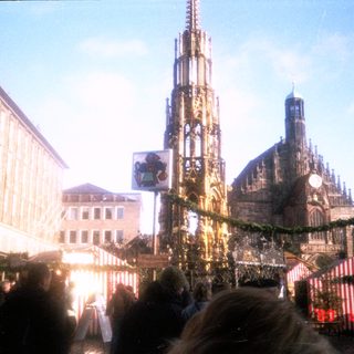 Christmas market with festive stalls and cathedral.