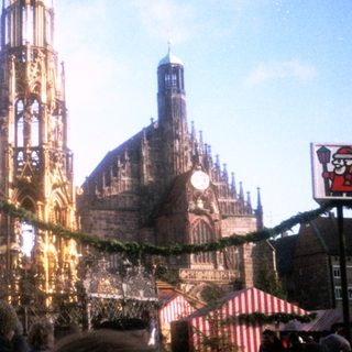 Christmas market with festive stalls and cathedral.