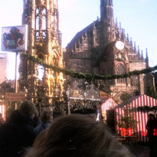Christmas market with festive stalls and cathedral.