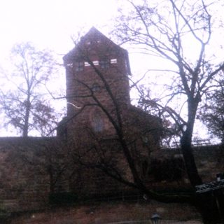 Medieval castle ruins with two towers.