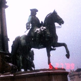 Equestrian statues atop historic monument.