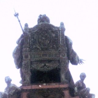Equestrian statues atop historic monument.