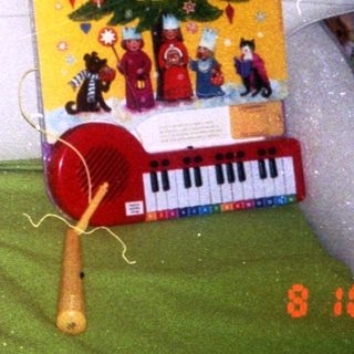 Baby playing indoors with toys, date 8.10.99.