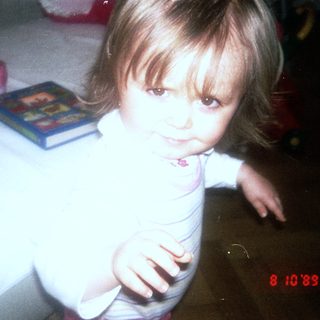 Young child sitting at table with toys.