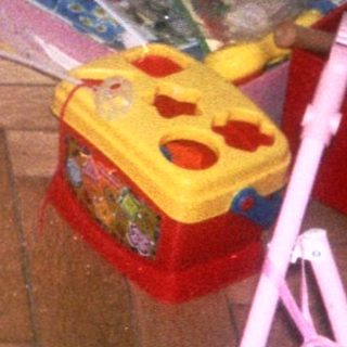 Young child playing with toys indoors.