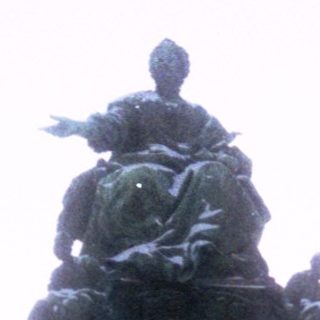 Equestrian monument with central figure atop pedestal.