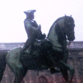 Equestrian statue monument with historical figures.
