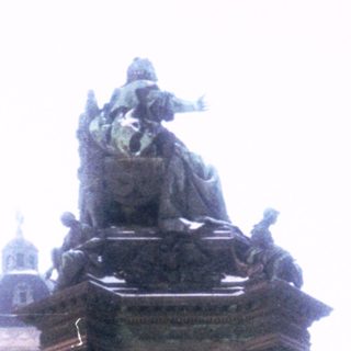 Equestrian statue monument with historical figures.