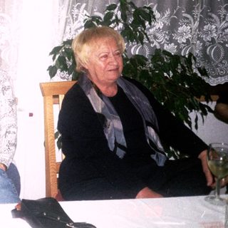 Three women sitting together indoors at a table.