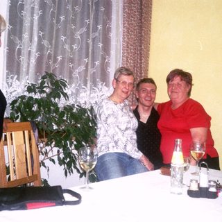 Four women enjoying a social gathering with drinks.