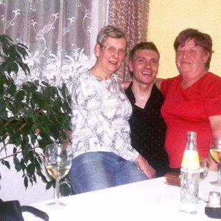 Four women enjoying a social gathering with drinks.
