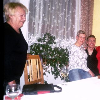 Four women enjoying a social gathering with drinks.