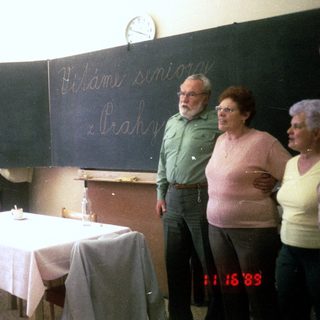 Group singing and playing accordion in classroom, 1983.