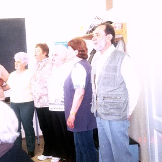 Group singing lesson or choir performance in classroom.