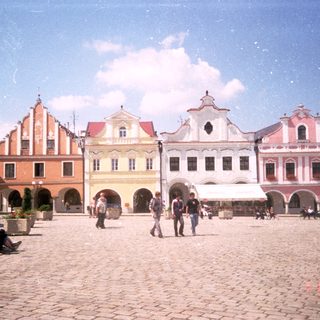 Historic European town square with colorful baroque buildings.
