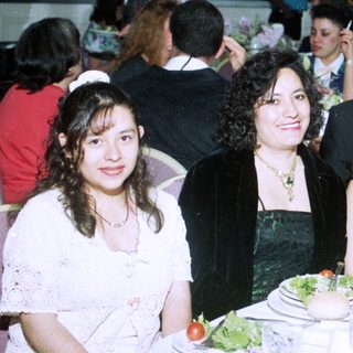 Formal event gathering with four people posing at a table.