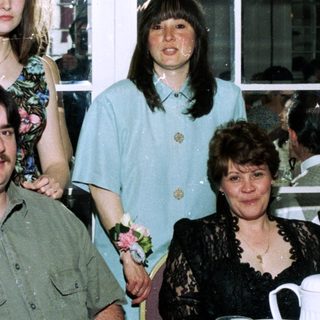 Family group photo at an indoor celebration.