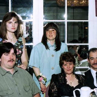 Family group photo at an indoor celebration.