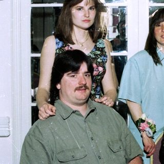Family group photo at an indoor celebration.