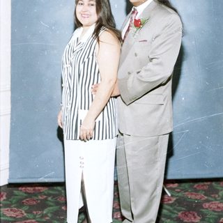 Couple posing formally in formal attire.