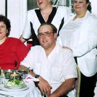 Group celebrating at a formal indoor dinner party.