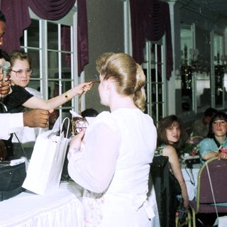 Wedding reception with bride receiving gifts.