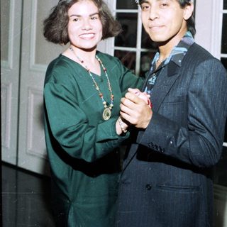 Two people dressed in festive holiday attire.