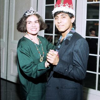 Two people dressed in festive holiday attire.