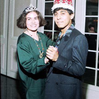 Two people dressed in festive holiday attire.