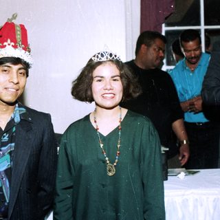 Two people dressed as king and queen at an event.