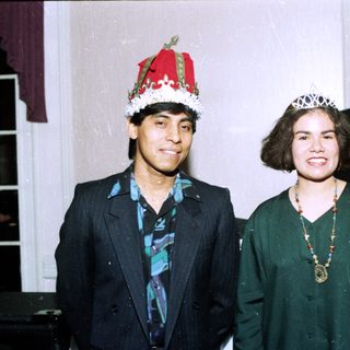 Two people dressed as king and queen at an event.