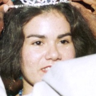 Girl receiving a tiara at a party.