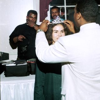 Girl receiving a tiara at a party.