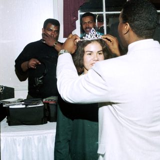 Girl receiving a tiara at a party.