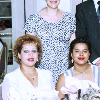 Family group posing at formal indoor event.