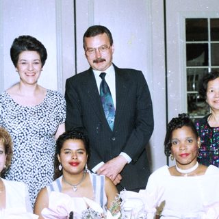 Family group posing at formal indoor event.