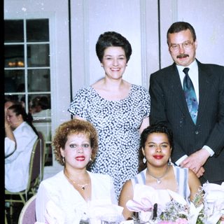 Family group posing at formal indoor event.