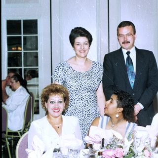Family group posing at formal indoor event.