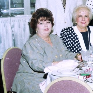 Group posing at a formal indoor banquet.