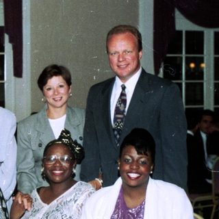 Group posing at a formal indoor banquet.