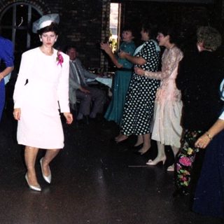 Formal dance party with 1950s-style attire.