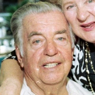 Joyful elderly couple posing together indoors.